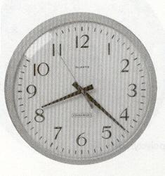 Analog clock with large, easy to read numbers on a white background.  Black hour and minute hands and blue second hand.  12 inch face.  Battery operated.  Brown case.