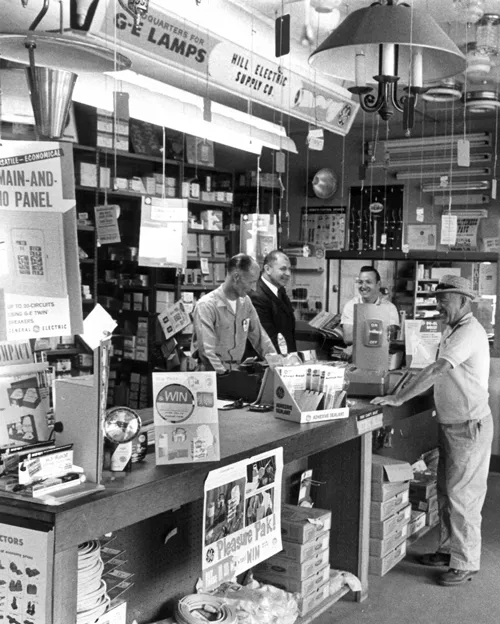 Founder of Hill Electric Supply greeting customers in 1964.
