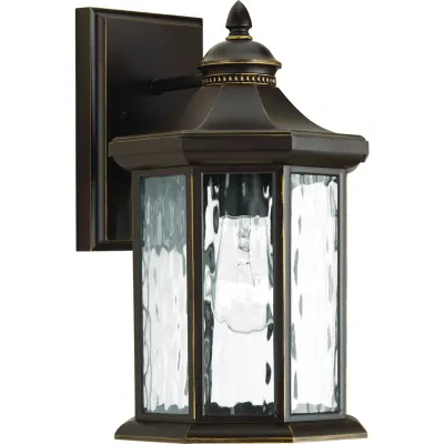 The one-light medium wall lantern in the Edition collection features distinctive octagonal shape for classic styling. Clear water glass elements are accented by a Antique Bronze fi...