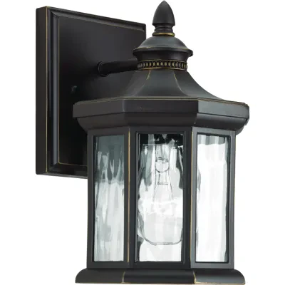 The one-light small wall lantern in the Edition collection features distinctive octagonal shape for classic styling. Clear water glass elements are accented by a Antique Bronze fin...
