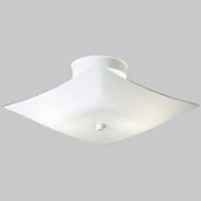 A modern close to ceiling fixture with a square white glass shade in a white finish. The fixture is ideal in either a bathroom or bedroom setting.
