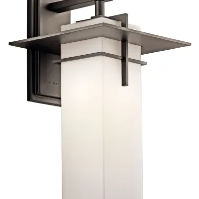This 1 light wall sconce from the Caterham(TM) collection is both versatile and charming. The Satin Etched Glass shade rests beautifully against the rich Olde Bronze finish.