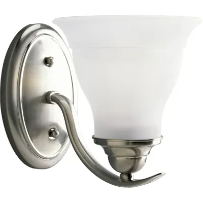 One-light bath fixture featuring soft angles, curving lines and etched glass shades that mount up or down. Gracefully exotic, the Trinity Collection offers classic sophistication f...